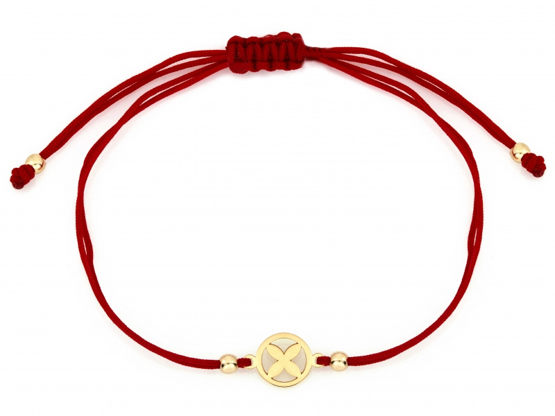 Złota bransoletka z kwiatkiem na czerwonym sznurku