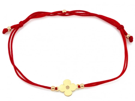 Złota bransoletka kwiatek na czerwonym sznurku