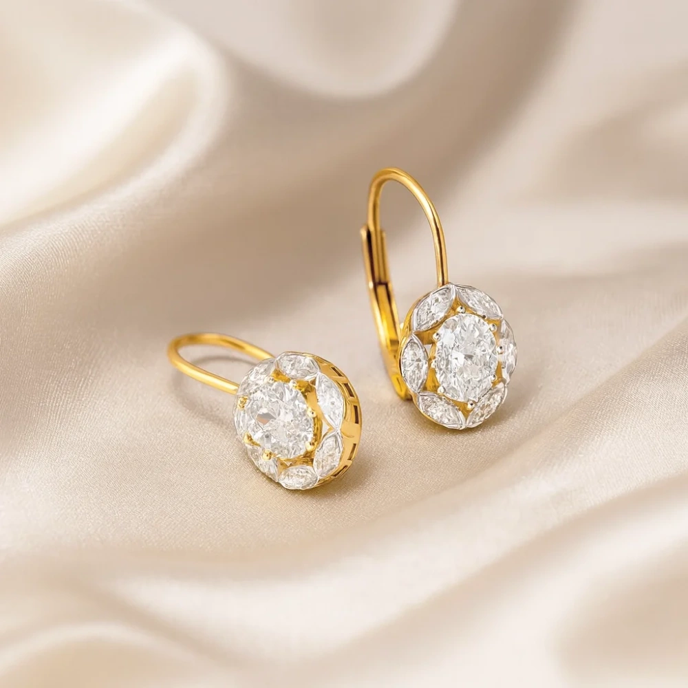 Złote kolczyki wiszące na biglu z cyrkoniami